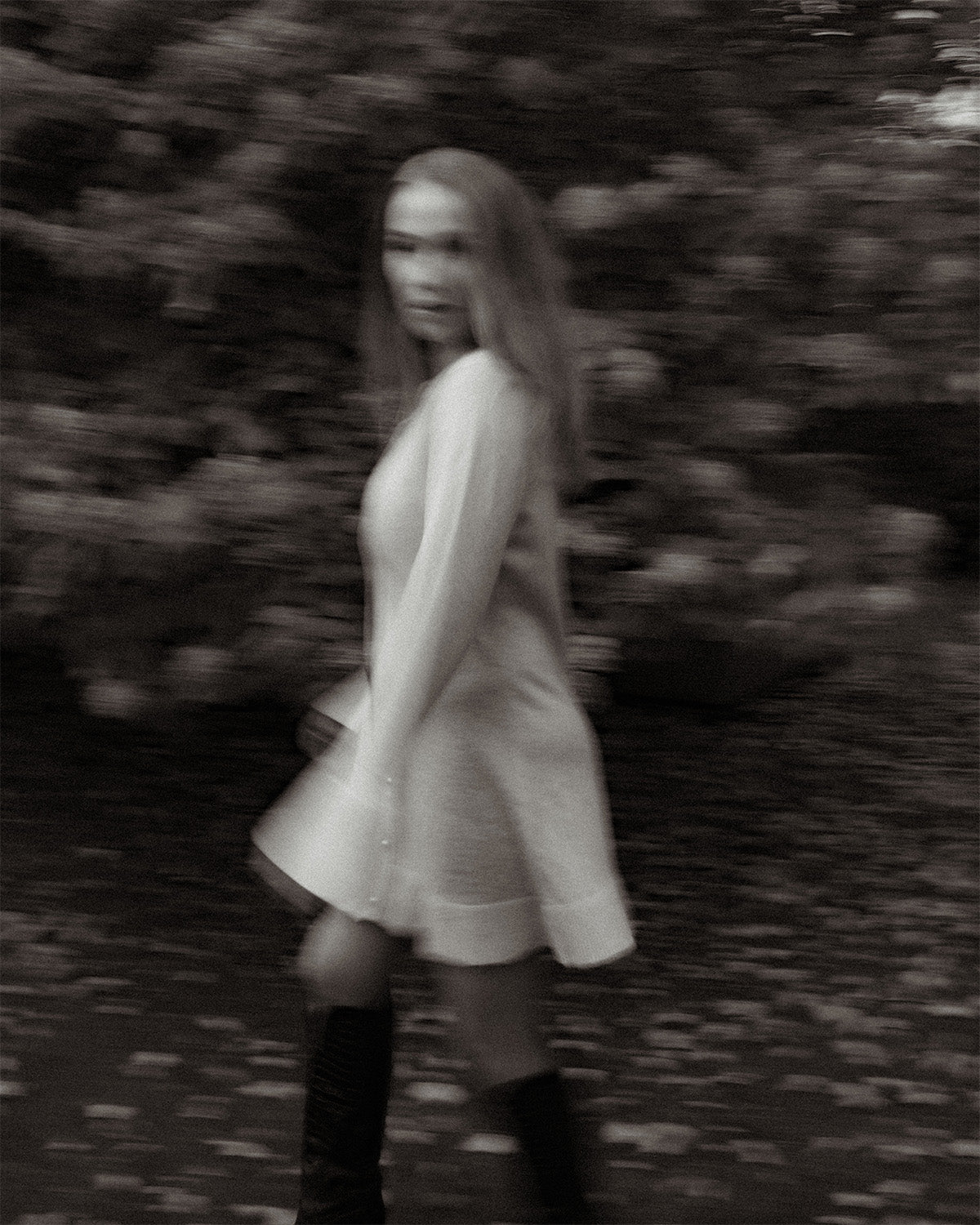 Woman in a light dress standing in a forest